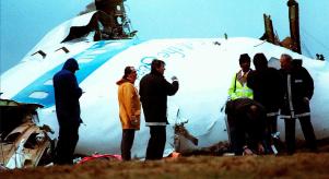 Crash investigators inspect the nose section of the crashed Pan Am Flight 103